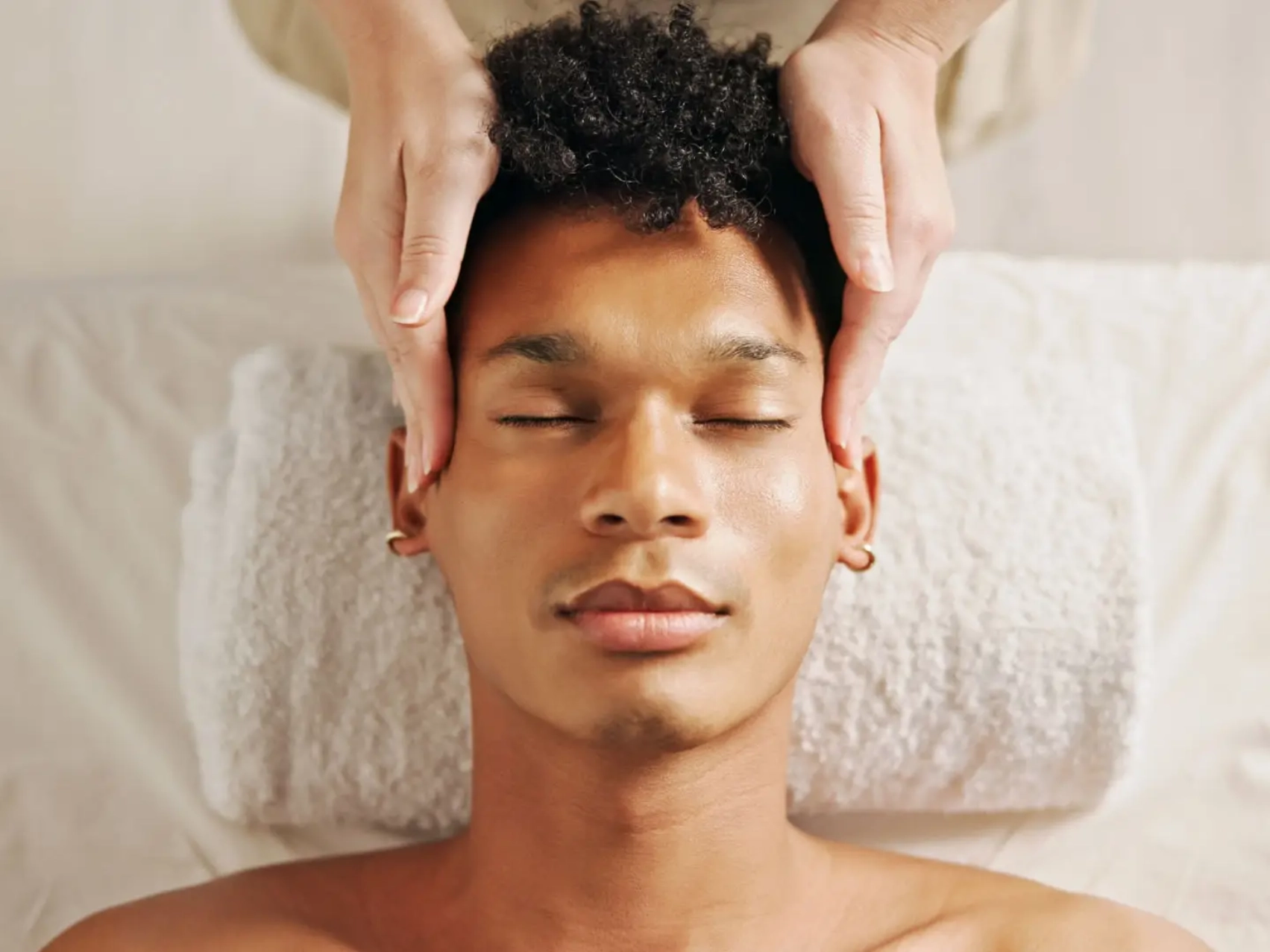 Man receiving relaxing head massage