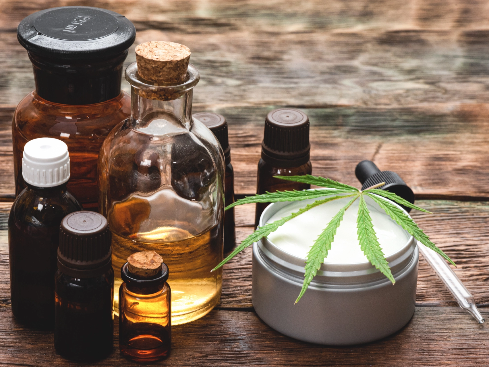 Hemp leaf with essential oil bottles