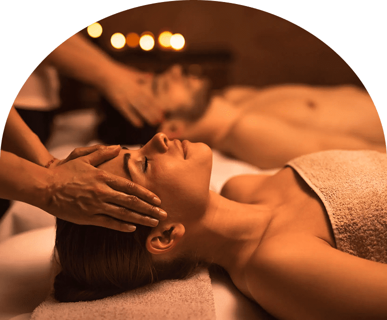 A woman receiving a relaxing facial massage in a spa.