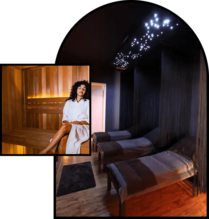 Cozy spa room with two massage beds and dim lighting.
