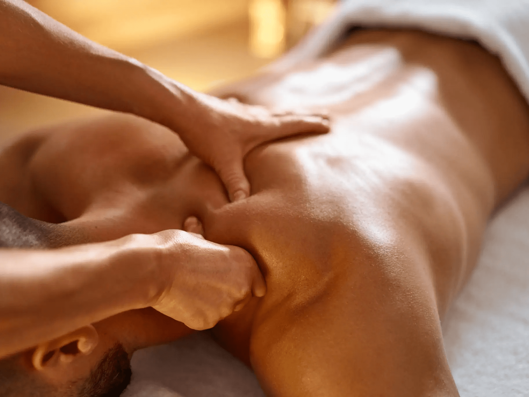 Hands giving a relaxing back massage.