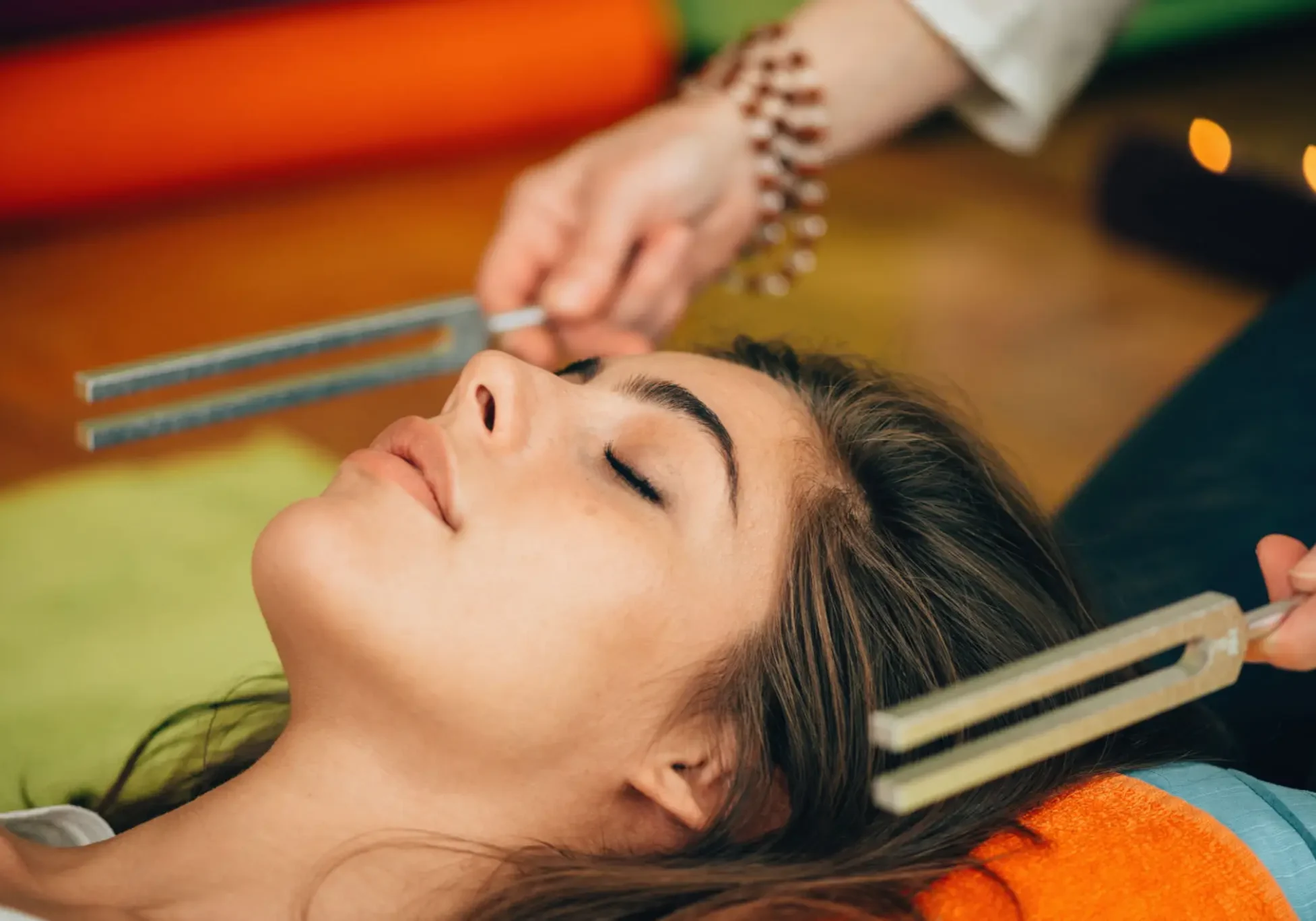 Peaceful woman receiving sound healing therapy